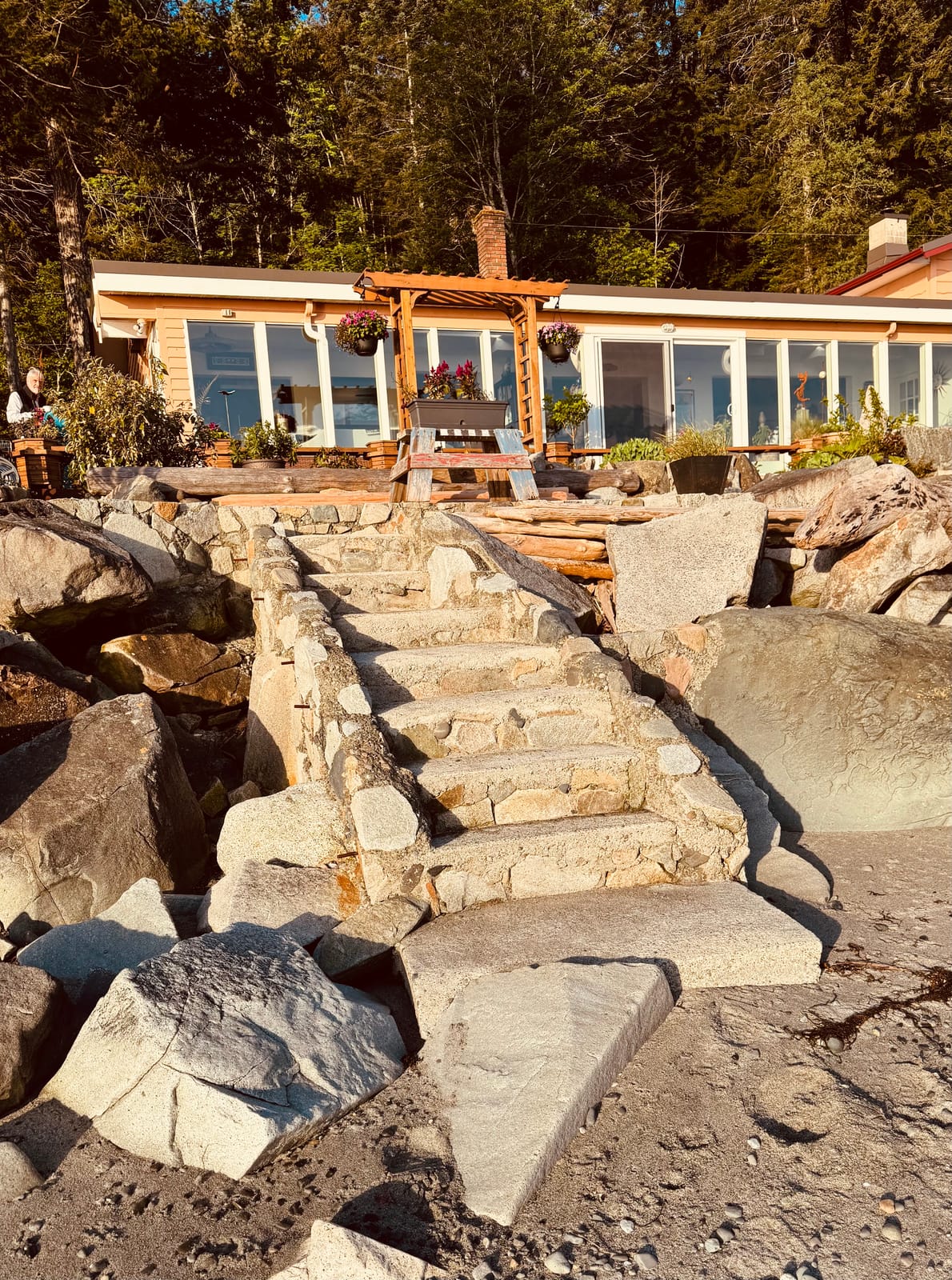 Stone steps from the deck down to the rocky beach